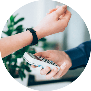 A person making a digital payment to a hand-held payment device using their watch. Specialists in Hybrid Event Management. Live Events Production and Virtual Event Management for Healthcare Industry: CODA Communications 
